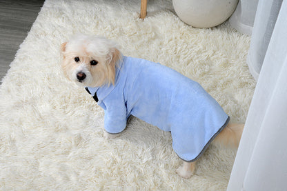 Small dog wearing blue Relvya DryWrap bathrobe on carpet