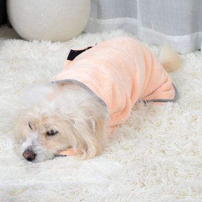 Dog resting in peach absorbent pet bathrobe