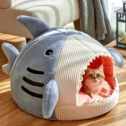 Shark-shaped pet bed with a cat resting inside